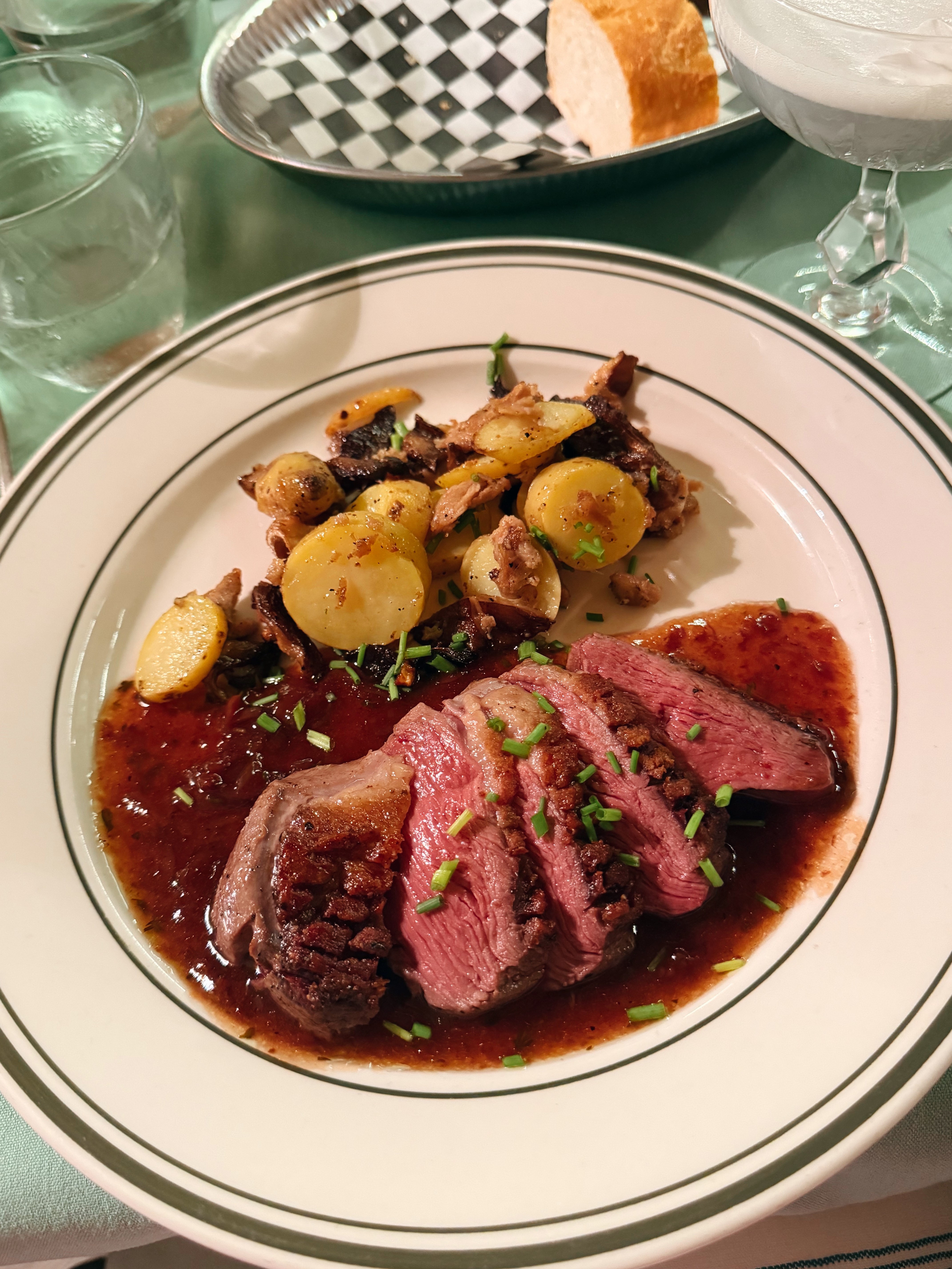 A plated steak dinner with roasted potatoes